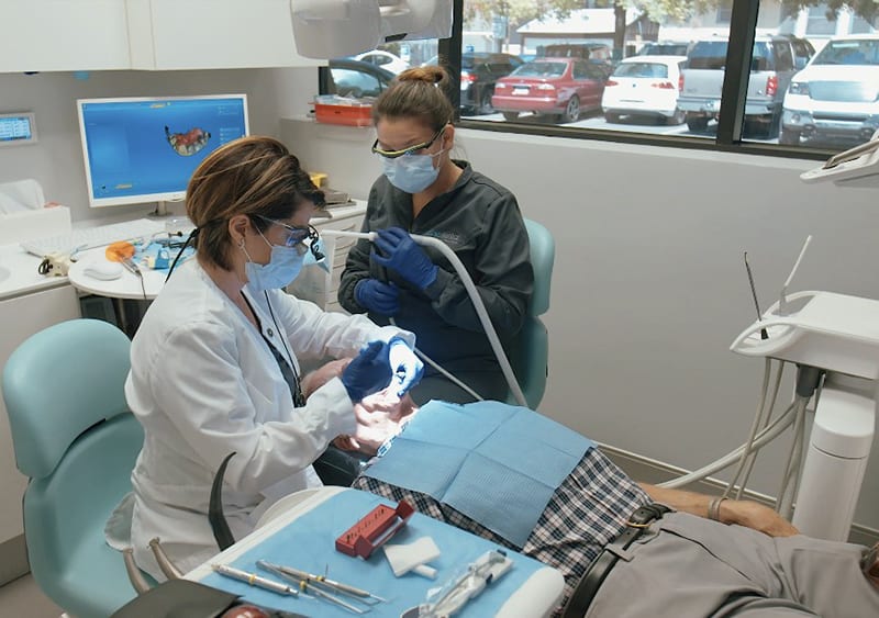 Dr. Jenny Apekian performing a dental filling procedure at Midtown Dental in Sacramento
